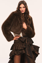 Load image into Gallery viewer, Model wearing a luxurious cropped faux fur jacket with wide cuffs and ruffled skirt