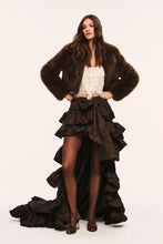 Load image into Gallery viewer, Model wearing a cropped dark brown faux fur jacket styled with ruffled skirt and lace top