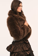 Load image into Gallery viewer, Model wearing a cropped fluffy faux fur jacket with long sleeves, paired with a ruffled taffeta skirt