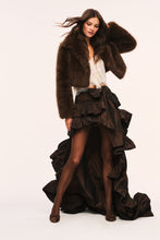 Load image into Gallery viewer, Model wearing a cropped brown faux fur jacket styled over a ruffled high-low skirt