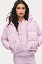 Load image into Gallery viewer, Model wearing a light pink floral quilted puffer jacket with hood, open over matching hoodie