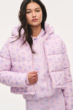 Load image into Gallery viewer, Model wearing a cropped floral puffer jacket with hood over matching floral hoodie