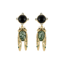 Load image into Gallery viewer, Gold-tone drop earrings featuring black onyx studs and green stone cicada pendants with crystal accents
