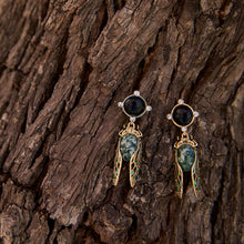 Load image into Gallery viewer, Gold cicada drop earrings with green moss agate wings and dark stone studs on tree bark