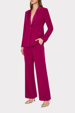 Load image into Gallery viewer, Woman wearing a single-button magenta blazer with satin lapel trim and wide-leg trousers