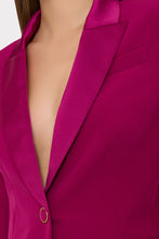 Load image into Gallery viewer, Close-up detail of a magenta blazer showing satin lapel trim and gold button closure
