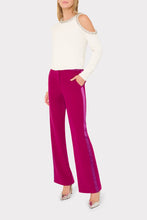 Load image into Gallery viewer, Wide-leg magenta trousers with satin side stripe trim worn with white cold-shoulder sweater