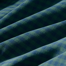 Load image into Gallery viewer, Close-up detail of gingham woven fabric showing green and blue plaid pattern with soft draping folds
