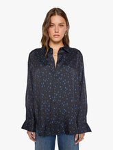 Load image into Gallery viewer, Model wearing oversized black button-down shirt with blue star print and flared cuffs