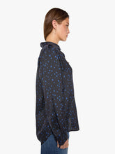 Load image into Gallery viewer, Side view of woman wearing long-sleeve button-up shirt with blue star print pattern