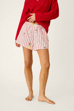 Load image into Gallery viewer, Model wearing red and white striped shorts with festive martini and mistletoe print pattern