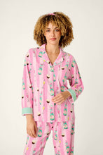 Load image into Gallery viewer, Model wearing pink striped pajama set with champagne and cupcake print, long sleeve button-up top