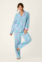 Load image into Gallery viewer, Woman wearing long-sleeve button-front pajama set with candy cane print on light blue background