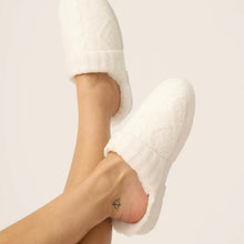 Load image into Gallery viewer, Person wearing ivory cable-knit plush slide slippers with fleece lining, feet raised