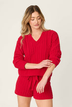 Load image into Gallery viewer, Model wearing a red cable knit V-neck pullover sweater paired with matching shorts