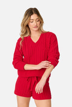 Load image into Gallery viewer, Model wearing red cable knit V-neck sweater paired with matching red drawstring shorts