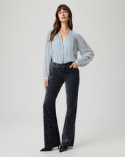 Load image into Gallery viewer, Model wearing dark navy velvet flare trousers with paisley pattern and light blue blouse