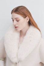 Load image into Gallery viewer, Model wearing a short sleeve jacket with oversized fluffy fur collar, looking downward