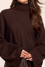 Load image into Gallery viewer, Close-up detail of a turtleneck sweater with wide bell sleeves and ribbed cuffs