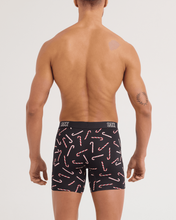 Load image into Gallery viewer, Back view of male model wearing black boxer briefs with candy cane pattern and Saxx waistband