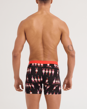 Load image into Gallery viewer, Back view of male model wearing black boxer briefs with festive gnome print and red waistband