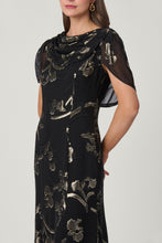 Load image into Gallery viewer, Model wearing black midi dress with gold metallic floral embroidery and sheer flutter sleeves