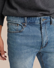 Load image into Gallery viewer, Close-up detail of men's medium wash blue denim jeans showing front pocket and waistband