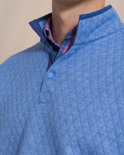 Load image into Gallery viewer, Close-up detail of quilted diamond-pattern snap pullover with plaid shirt layered underneath
