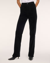 Load image into Gallery viewer, Model wearing high-waisted black corduroy bootcut pants with patch pockets and kitten heels