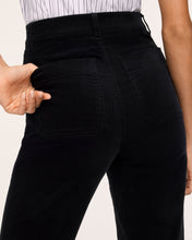 Load image into Gallery viewer, Close-up back view of high-waisted black corduroy bootcut jeans with patch pockets