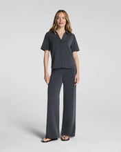 Load image into Gallery viewer, Model wearing short-sleeve button-down shirt with wide-leg trousers in dark charcoal tone