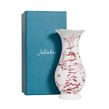 Load image into Gallery viewer, White porcelain vase with red winter toile scene beside teal Juliska gift box