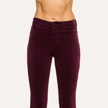 Load image into Gallery viewer, Close-up front view of high-rise velvet flare trousers on a model, cropped at torso