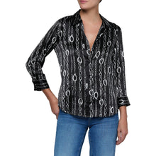 Load image into Gallery viewer, Woman wearing a black chain-print blouse with three-quarter sleeves and V-neckline paired with jeans
