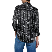 Load image into Gallery viewer, Back view of a woman wearing a black blouse with vertical chain link pattern and rolled sleeves