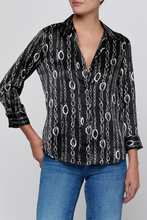 Load image into Gallery viewer, Model wearing a black satin blouse with silver chain print and three-quarter sleeves