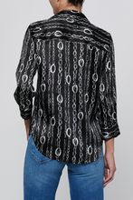 Load image into Gallery viewer, Back view of a black blouse with silver chain print and three-quarter sleeves on model