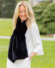 Load image into Gallery viewer, Woman wearing a luxurious faux fur scarf over a white outfit outdoors